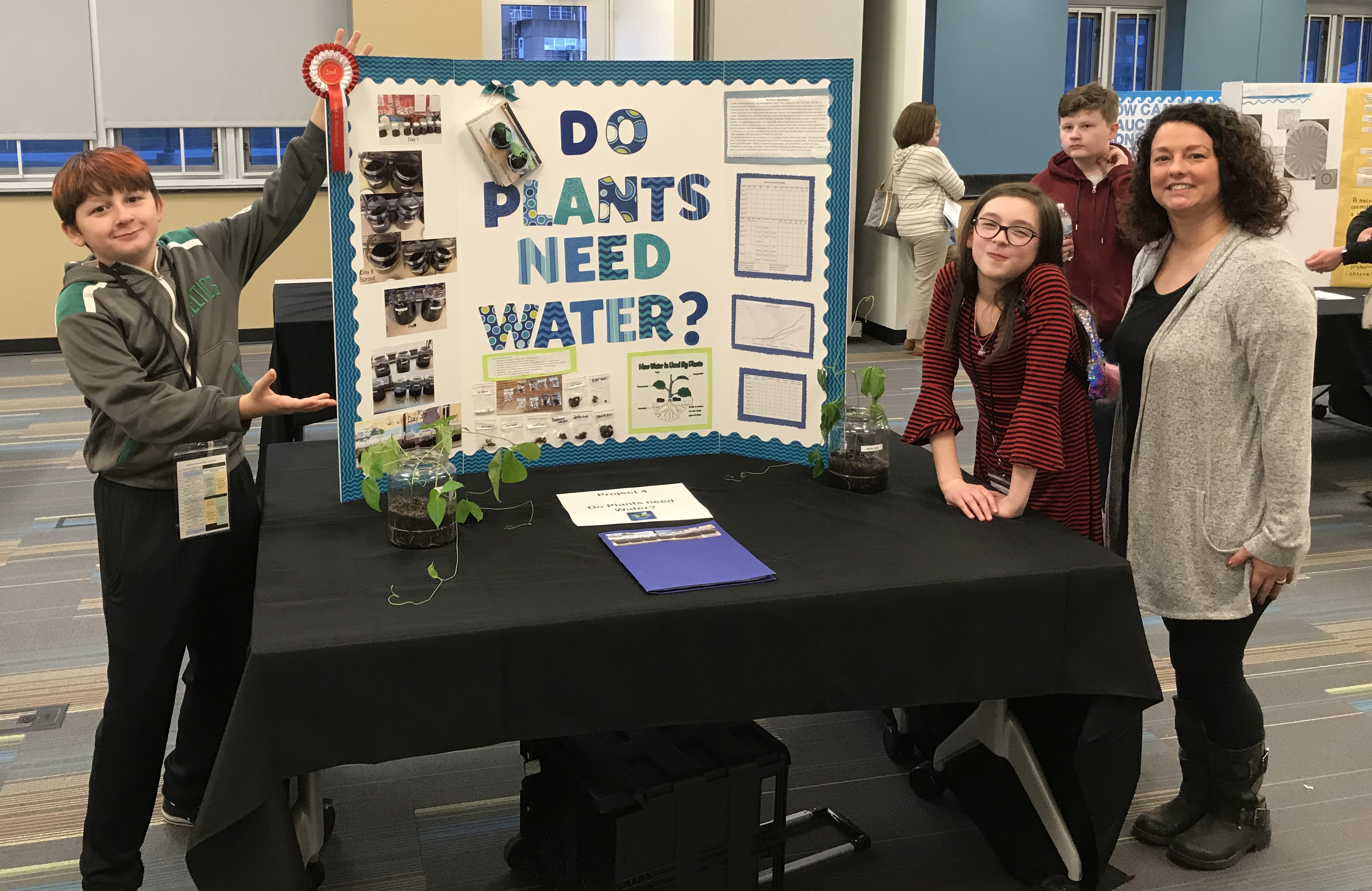 Lakewood Elementary students and teacher Jessica Blake pose with their second-place project, 'Do Plants Need Water?'