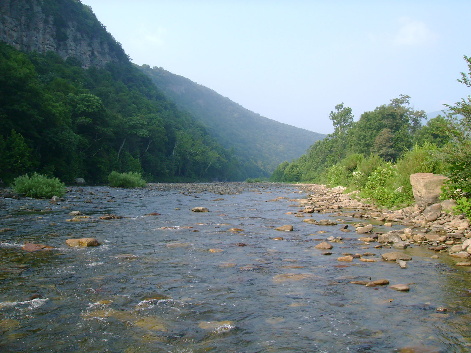 A river shoal with mountains in the background