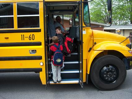 Yellow school bus with childern boarding