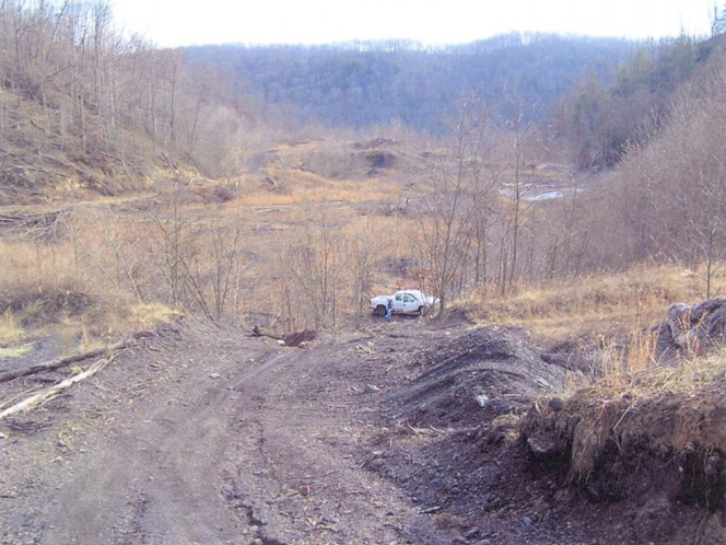 This photo shows the abandoned, partially vegetated 20 acre refuse area with its highly erodable and unstable outslopes.
