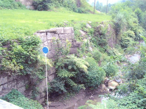 This photo shows one section of the failing cut stone retaining wall partially blocking stream flow along Laurel Branch. Further collapse of the wall would have blocked stream flow causing nearby homes to be flooded or even destroyed if the refuse embankment itself were to fail.