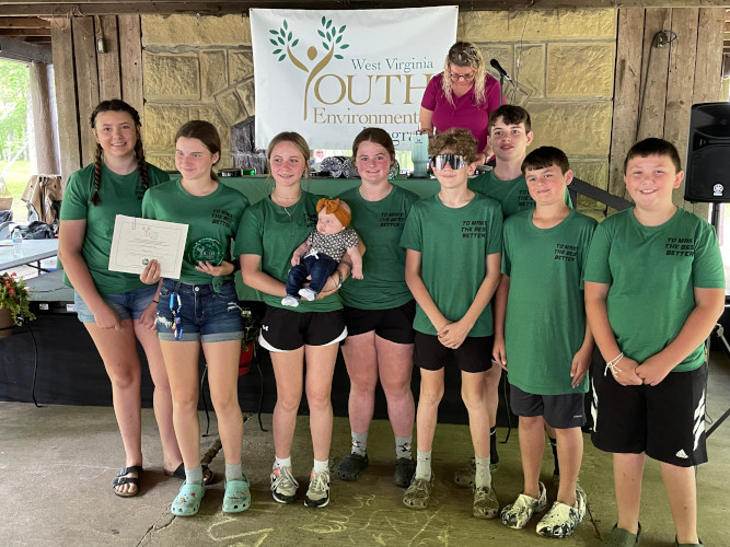 Members of the Letart Pioneers 4-H Club from Mason County pose for a group photo. One of the members is holding a baby.