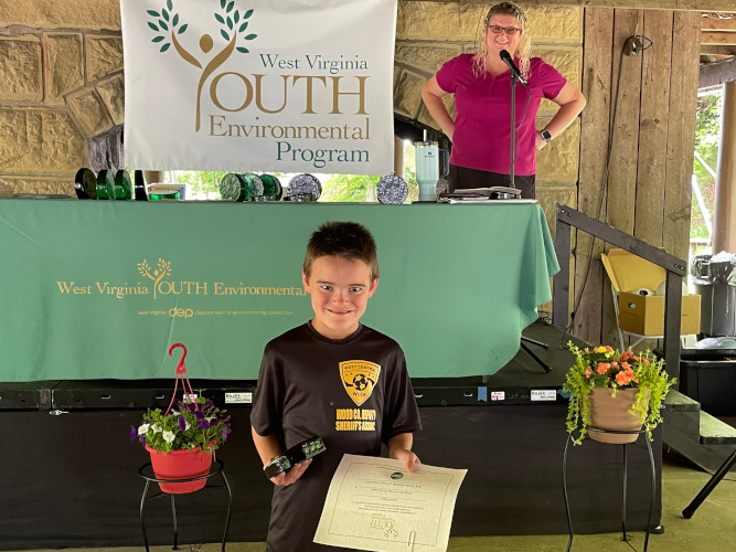 Karson Pigott, from the Belleville 4-H Club from Wood County, poses for a photo with his glass award and certificate.