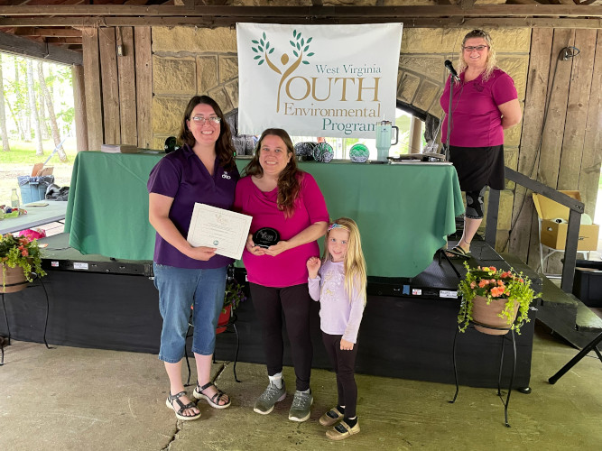 A representative from Lewis County's Leading Creek Elementary and a youth pose for a photo with Beth Henry-Vance of the DEP's Youth Environmental Program.