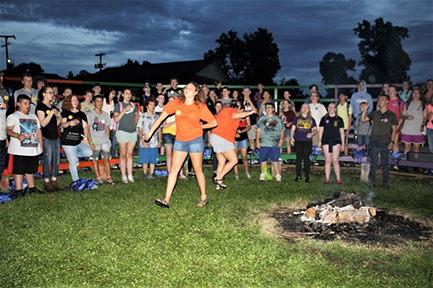 JCC group photo around a campfire.