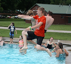JCC attendees jumping into a pool.