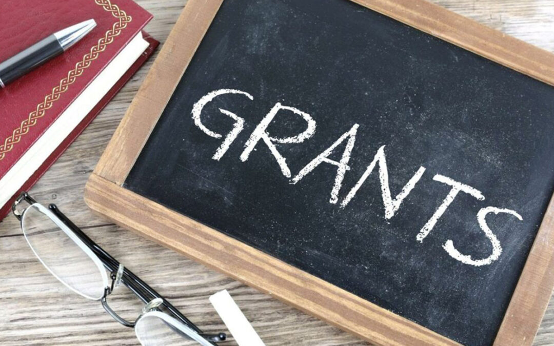 A small chalkboard with the word 'grants' written on it.